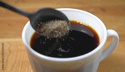 Adding Sugar to Coffee Close Up Shot of Brewing Process