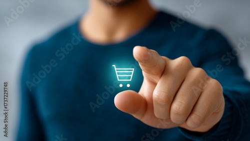 Person's finger presses glowing shopping cart icon on digital interface