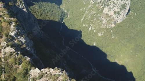 Drone footage of Vikos Gorge in Epirus, Greece, showing steep cliffs, lush greenery, and dramatic mountain landscape. Perfect for travel, nature, and documentary projects.