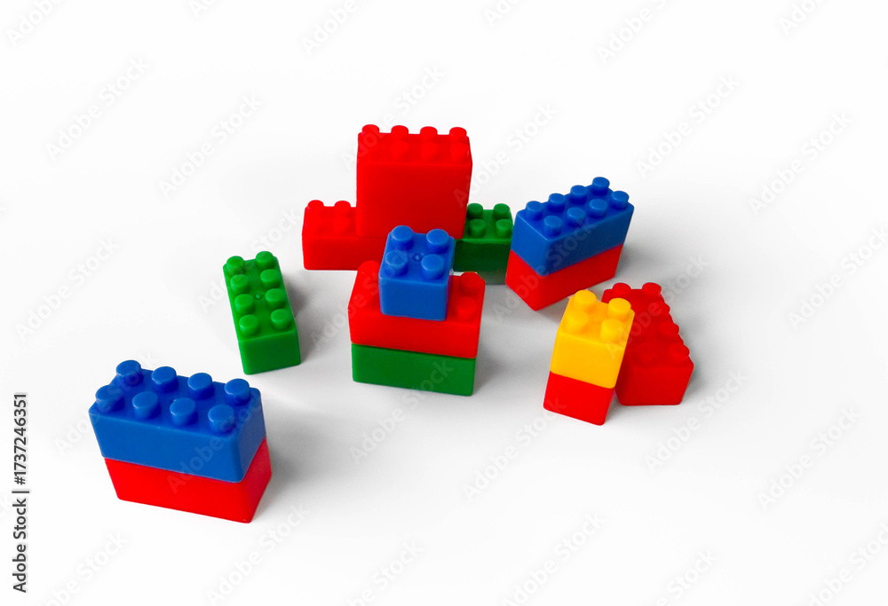 Fototapeta premium Colorful plastic toy building blocks arranged on a white background. 