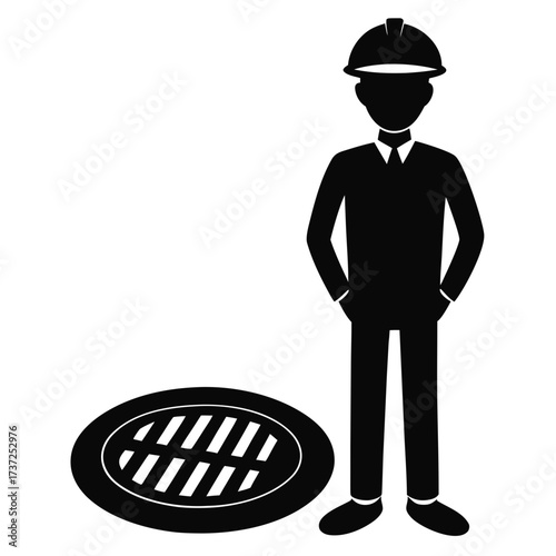 Construction worker standing next to a manhole cover silhouette