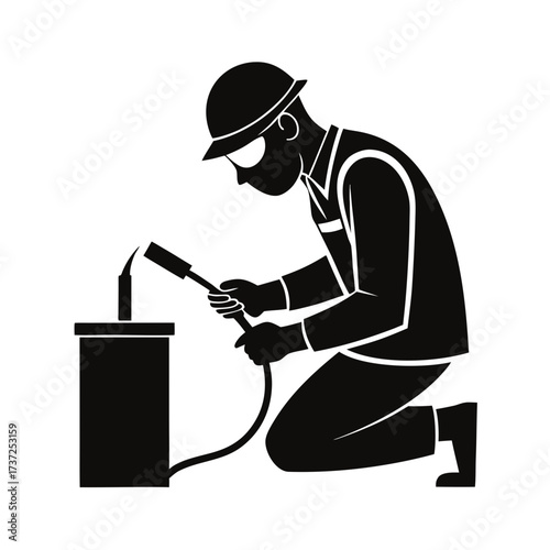 Welder working with torch in silhouette