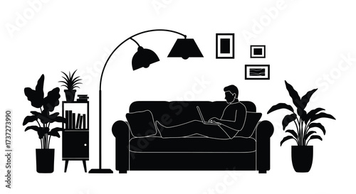 A man working on a laptop on a sofa in a living room