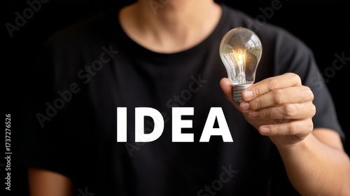 Man holds idea light bulb creativity sparks innovation, concept of bright idea and inspiration conveyed visually.