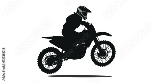 Silhouette of a motocross rider skillfully maneuvering a dirt bike mid air