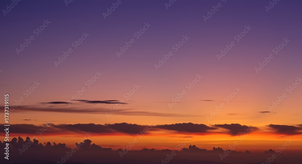 Fototapeta premium Vibrant sunset sky gradient showcasing a powerful color transition from fiery orange to deep purple twilight