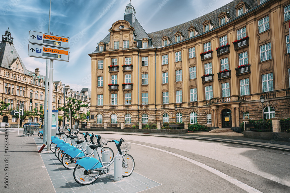 Fototapeta premium LUXEMBOURG. Row of city bikes for rent on a background of bank building