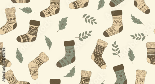 A cozy autumn pattern featuring knitted socks and falling leaves.