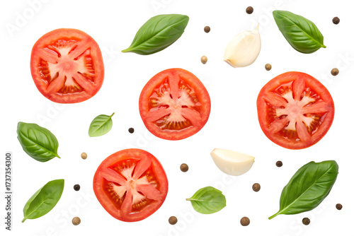 Sliced tomatoes basil leaves garlic cloves and peppercorns on black background tomato slices