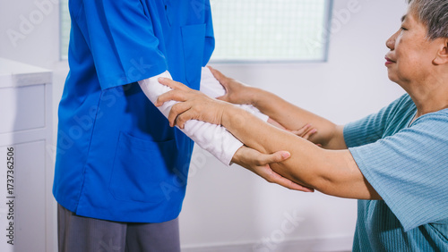 Bilde på lerret An Asian female nurse provides caring home care to an elderly woman, assisting w