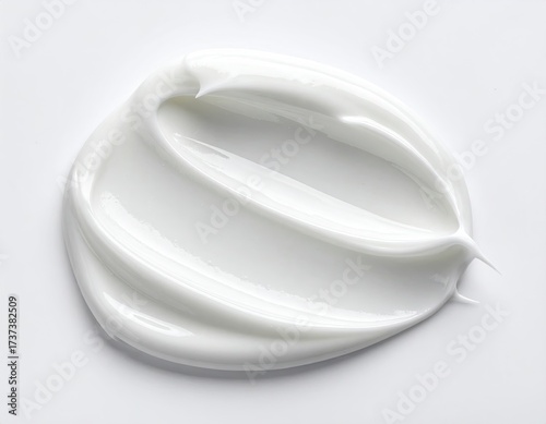 A close-up shot of a swirl of smooth, white cream on a bright white background