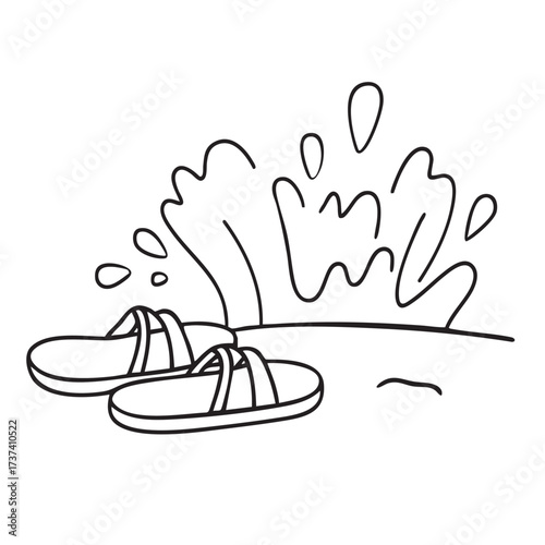 A pair of sandals on sandy beach, splashed by incoming waves