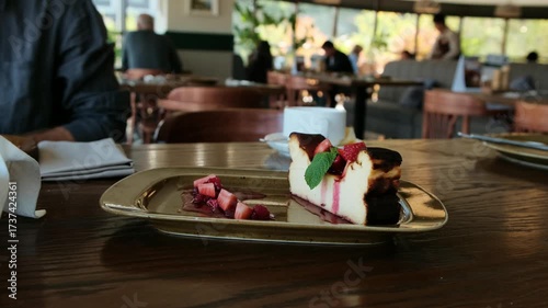 Close-up of a beautiful, delicious cottage cheese casserole with fresh strawberries served in a restaurant. Ideal 4K video for food ads, menus, and culinary content.