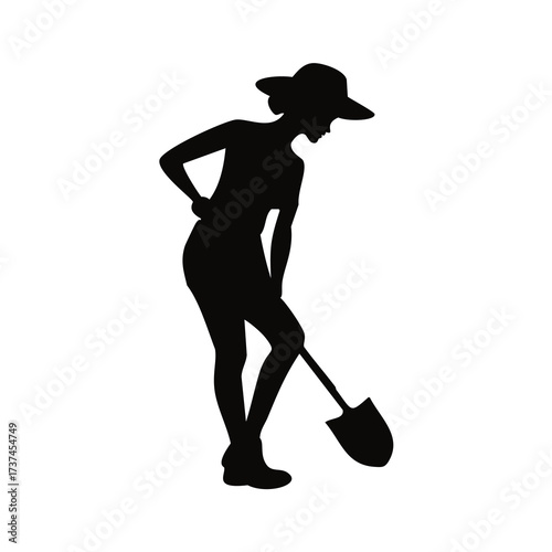 Silhouette of a woman with a shovel digging in the ground