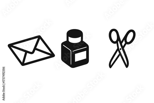Crafting supplies for a creative project featuring an envelope, ink bottle, and scissors