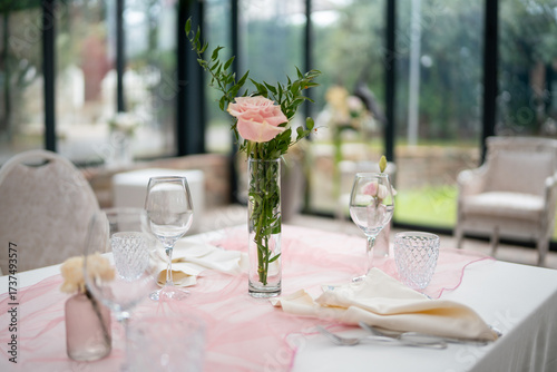 Elegant private event venue table setting prepared for an intimate lunch gathering with delicate floral arrangements and soft ambient lighting creating a sophisticated atmosphere
