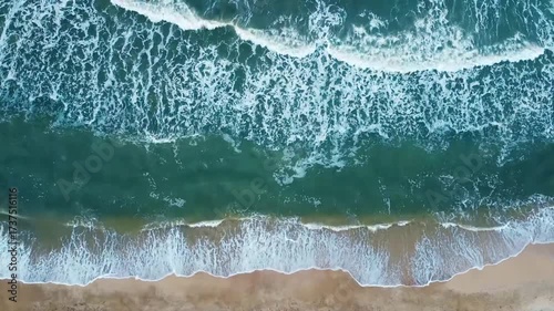 Aerial view of sand beach. Top view sea waves. Drone footage