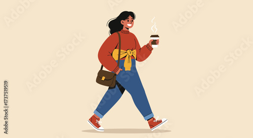 Woman walking with coffee wearing overalls and a sweater.