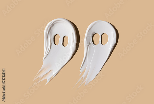 Halloween concept, ghosts in the form of cosmetic smears on a beige background. Moisturizing the skin in autumn. Autumn concept.