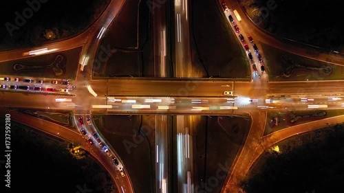 A highway with a lot of traffic. The bridge is lit up at night. Aerial view Larkin night traffic