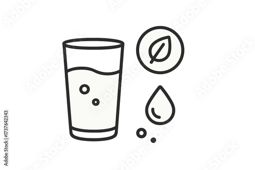 Glass of pure drinking water with natural leaf and refreshing water drop