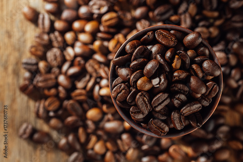 Close-Up of Dark Roasted Coffee Beans in a Brown Bowl on Wood