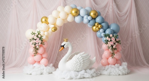 Swan sculpture under balloon arch with elegant pink backdrop for party