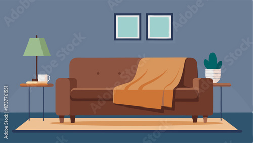 A living room with a cozy oversized knit blanket draped over a contemporary leather sofa surrounded by minimalist wood and metal side tables.