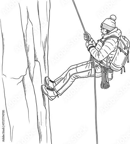 Adventurous person rappelling down rocky cliff in winter gear with rope and harness, outdoor extreme sport in cold mountain terrain