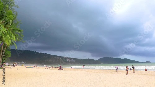 Storm heavy monsoon rain clouds wild waves Patong Beach Thailand.
