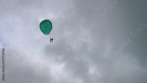 Patong Beach Phuket with turquoise blue water and parasailing Thailand.