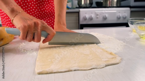 Pastry chef dividing dough cutting with knife on kitchen table cooking dessert. Create delicious healthy food pastry. Cuisine culinary prepare homemade cook domestic meal baking recipe ingredients.