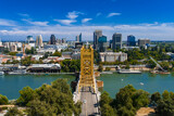 Aerial view of Sacramento, California, featuring the golden Tower Bridge over the Sacramento River, city skyline, and State Capitol Building.
