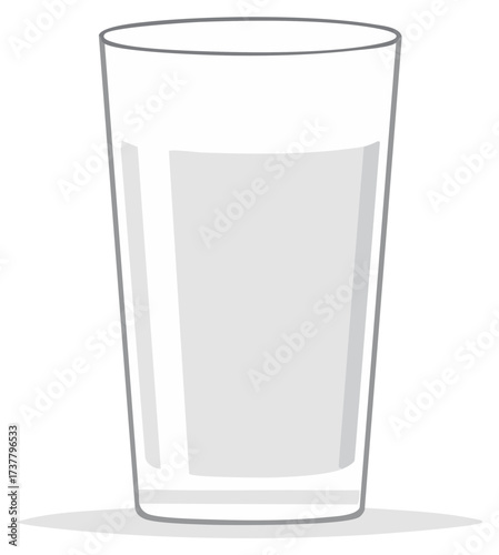 A tall clear glass filled with white liquid casting a soft shadow on a white surface