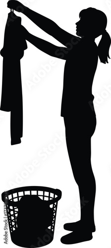 Silhouette of woman holding shirt for laundry, clothes washing concept, household chores, cleaning routine, domestic work, washing, organizing, home lifestyle