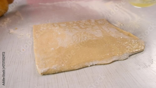 Baker woman hands smearing dough silicone brush with egg white cooking dessert. Create delicious healthy food pastry. Cuisine culinary prepare homemade cook domestic meal baking recipe ingredients.