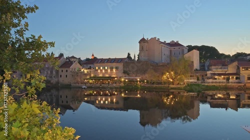 Twilight in the City of Trebinje casts a warm glow on the historic bridge and tranquil waters - Bosnia and Herzegovina 