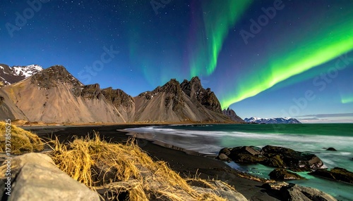 Majestic Aurora Borealis Over Stokksnes Mountains and Black Sand Beach with Golden Grass Iceland Nightscape