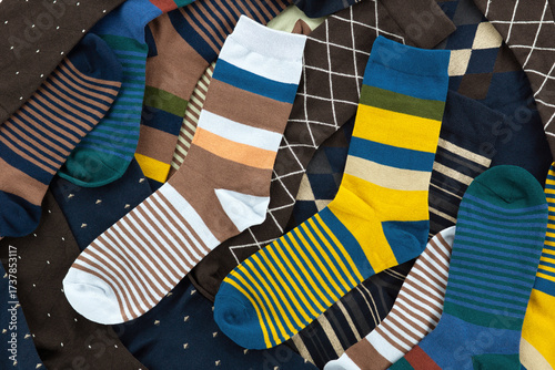 Multicolored and classic men's socks. Men's socks are folded in a pile.