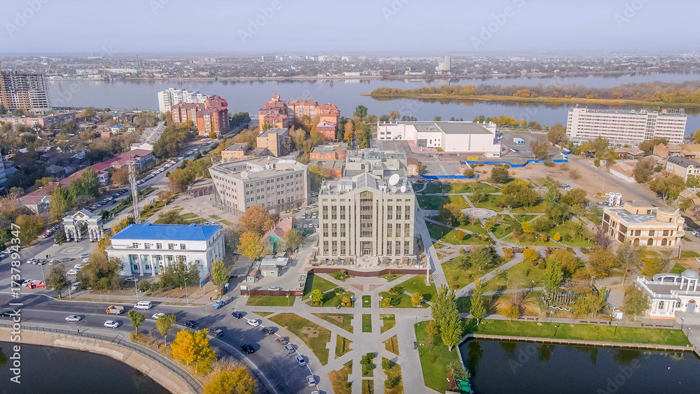 Obraz premium Lukoil office building in Astrakhan, Russia, with business center, park, Volga River, autumn daytime. 
