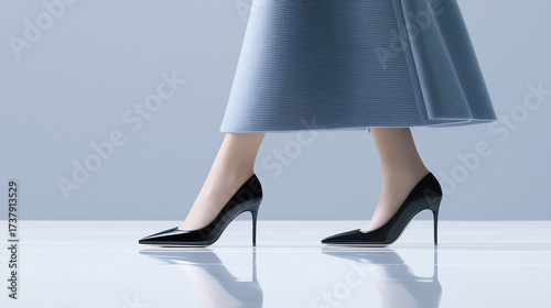 Elegant high-heeled shoes on a reflective surface.