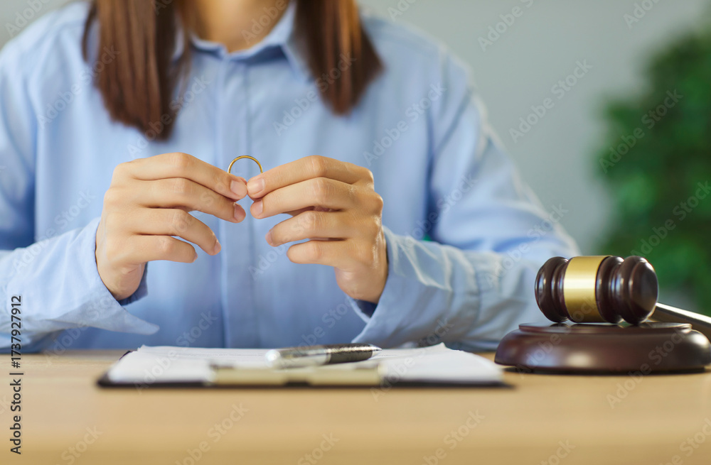 Obraz premium Divorce court scene with ring and gavel shows broken marriage, legal process and family conflict. It illustrates justice, paperwork and official trial in separation cases. Divorce is final decision.