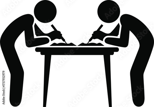 Two people writing at a table with pens and paper desk