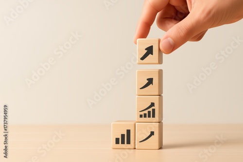 Hand Placing Wooden Blocks with Growth Symbols for Business Progress and Success Concept
