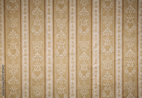 Old wallpaper on the wall. Old wallpaper for texture or background.