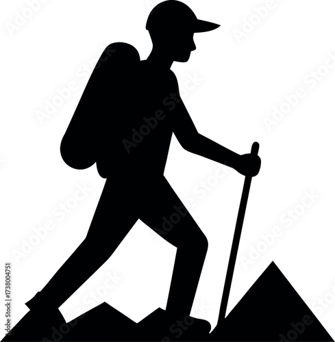 Silhouette of Man Hiking with Backpack and Walking Stick on Mountain Path