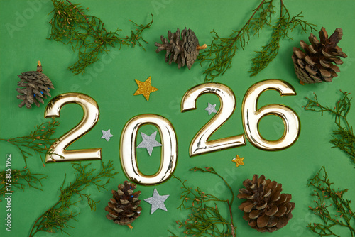 Golden 2026 Celebration Numbers With Pinecones And Green Holiday Backdrop