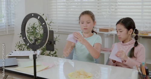 Two girls open youtube channel to teach paper folding 4k video.