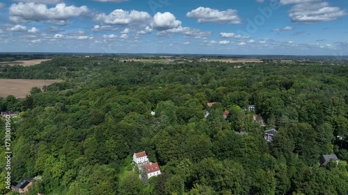 Aerial view of Genappe municipality and city of Wallonia located in the Belgian province of Walloon Brabant. Villas with garden surrounded by forest.