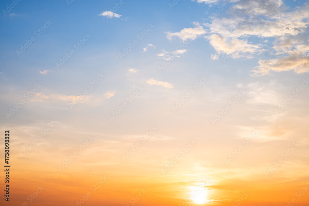 Obraz premium Beautiful , luxury soft gradient orange gold clouds and sunlight on the blue sky perfect for the background, take in evening,Twilight, Large size, high definition landscape photo